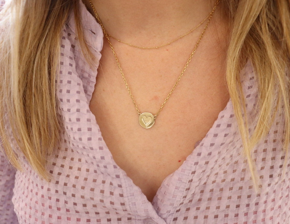 9ct gold Star disc necklace on women's neck