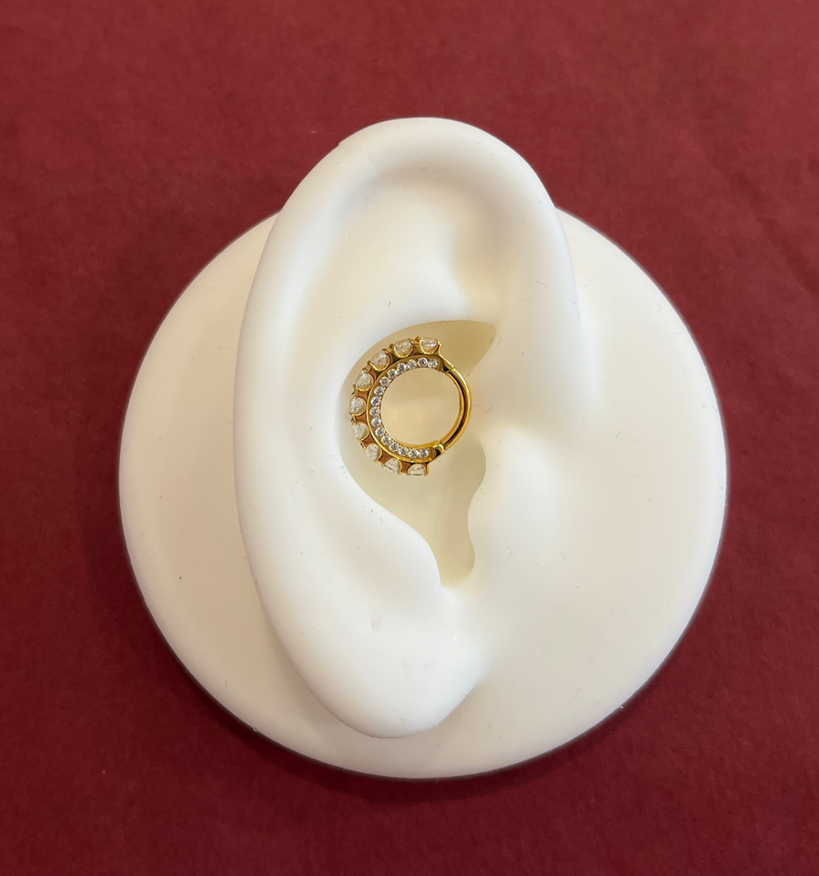 Gold pvd titanium clicker with Pàve and side facing crystal