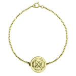gold plated dara knot symbol bracelet against a white background