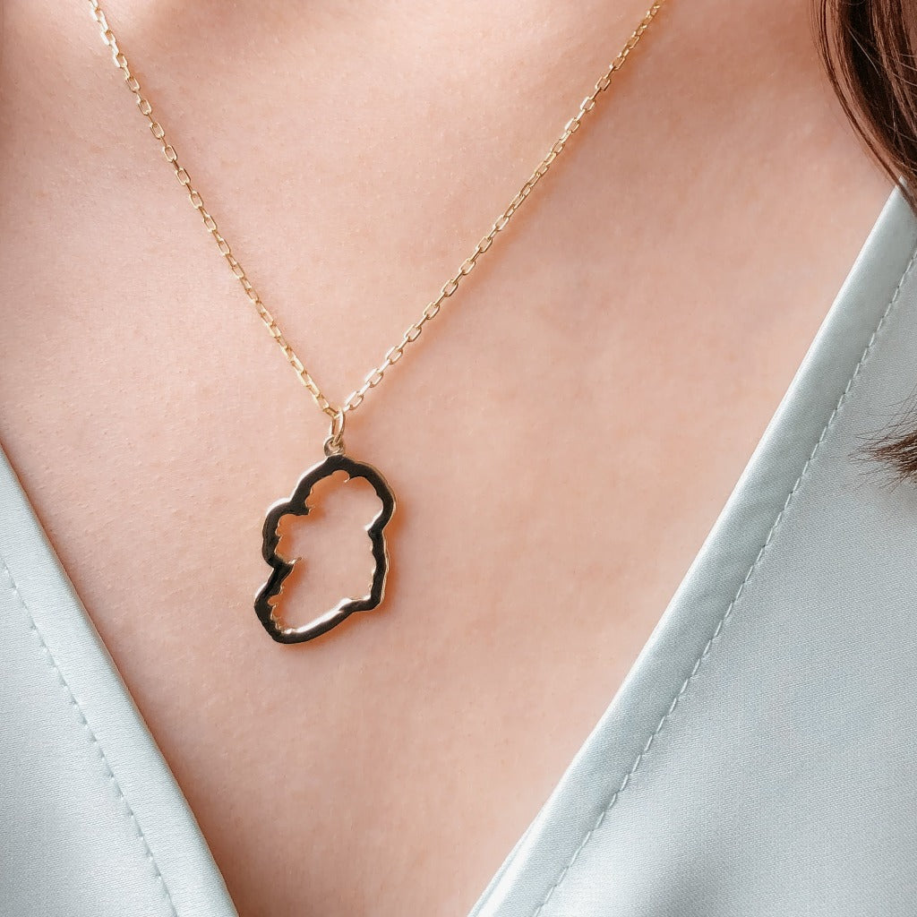 9ct gold map of ireland necklace on girls neck