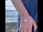 a video of a sterling silver dara knot bracelet symbolising strength on a women's wrist